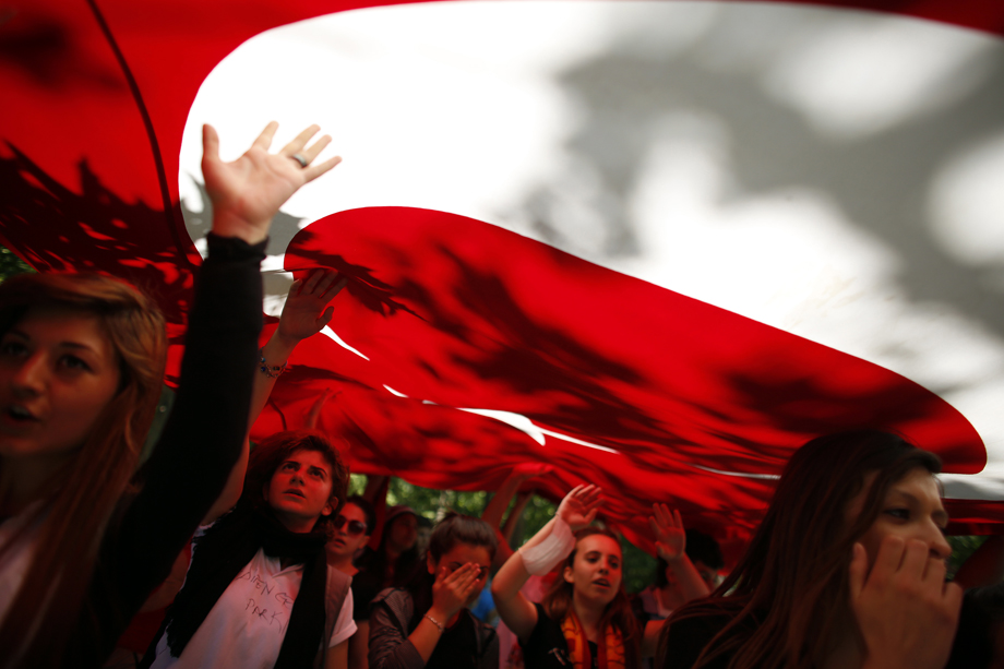 Protesters carry the Turkish flag and shout anti-government slogans during a demonstration at Gezi Park near Taksim Square in central Istanbul