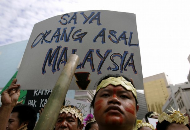 An indigenous Malaysian holds placard during demonstration in Kuala Lumpur